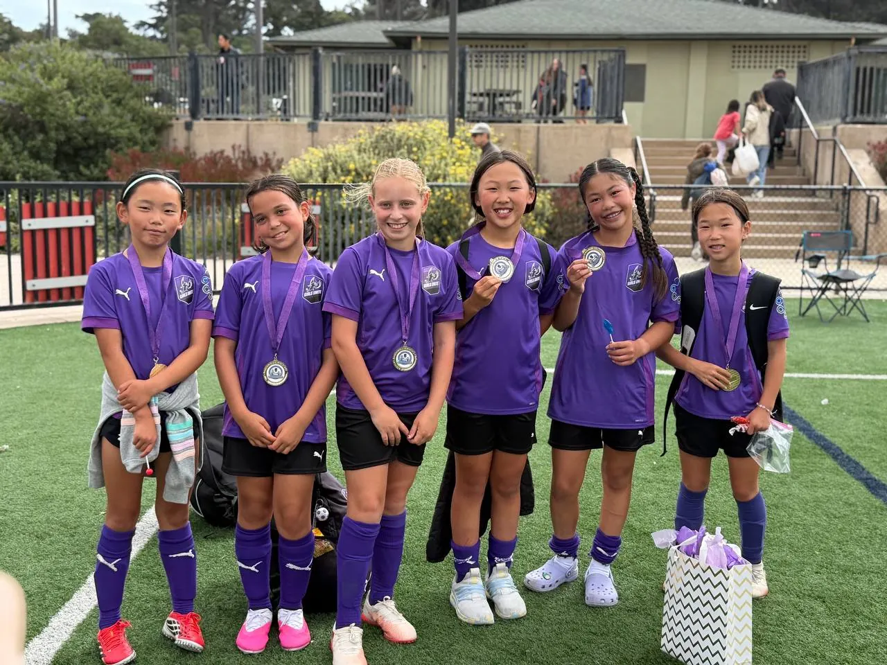 Wisdom Purple Pickles tournament champions holding their medals
